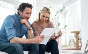 man and woman looking at papers making an informed decision